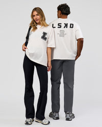 Duo wearing Hype Heavyweight Unisex Oversized Tee - Off White-Black | Model:Xavier | Size:L | Model:Brylee | Size:XS | Thumbnail Index: 2