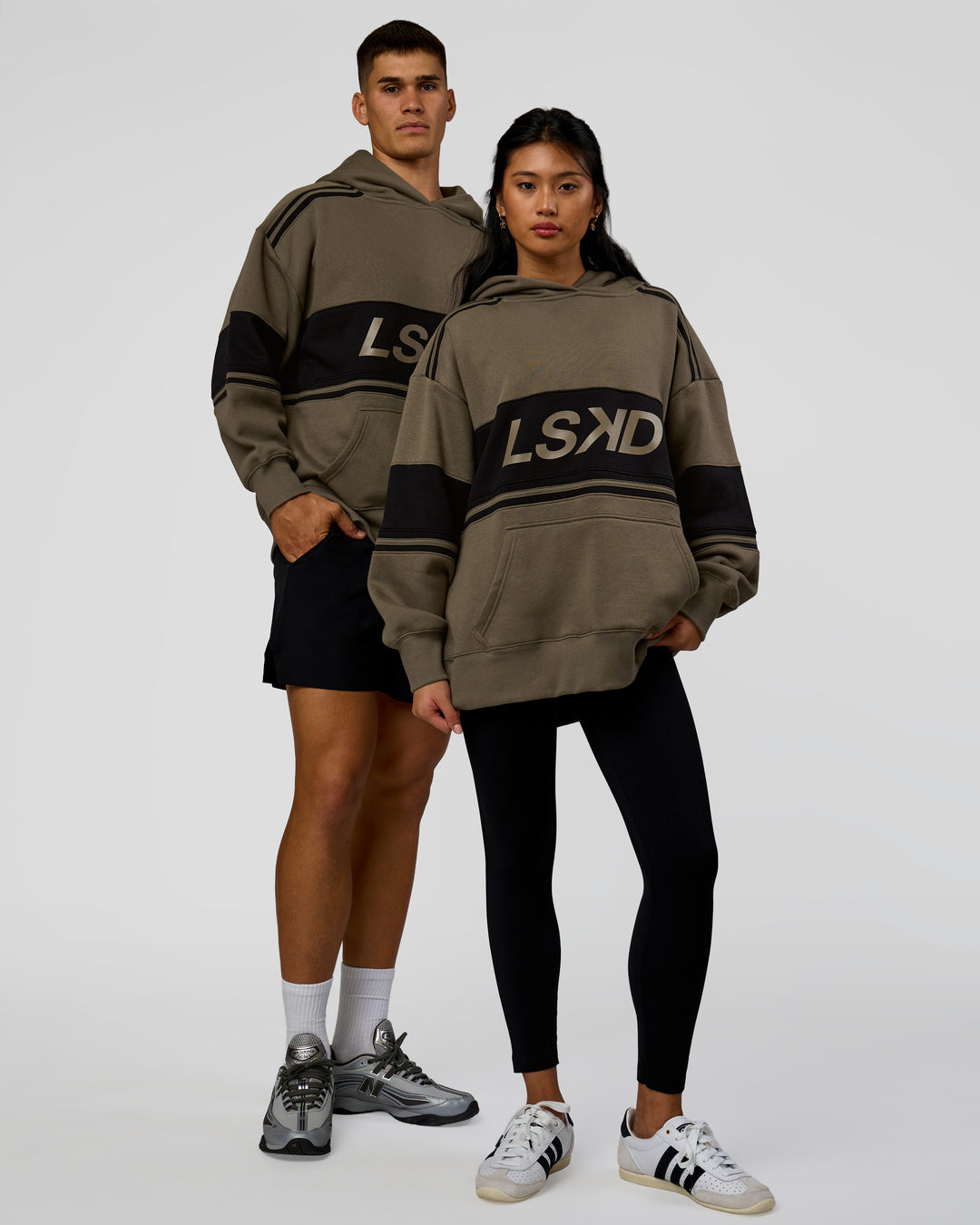 Duo wearing A-Team Oversized Hoodie - Walnut Grey-Caviar | Model:Jackson | Size:L | Model:Loren | Size:XS - view 1