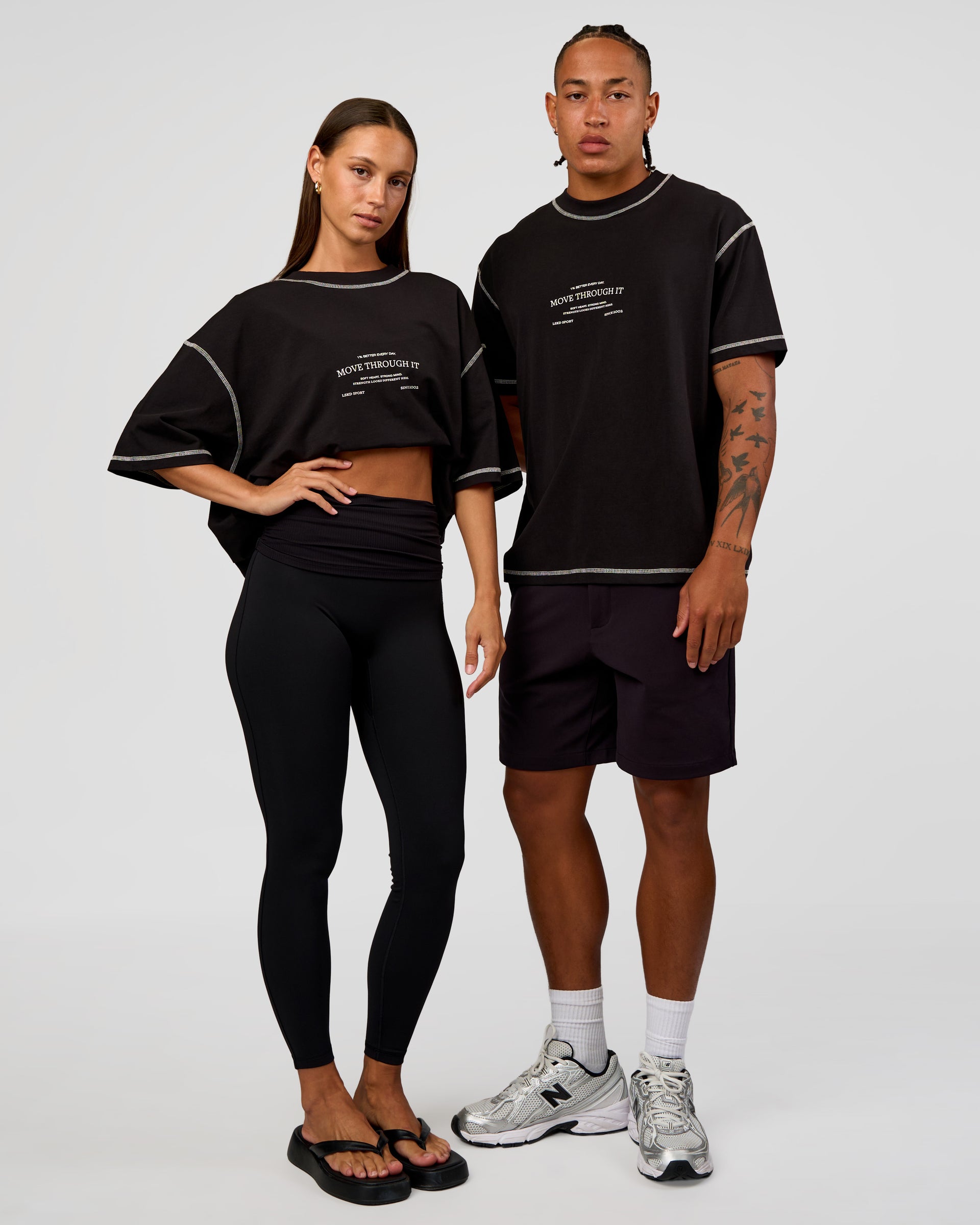 Duo wearing CF Unisex Oversized Heavyweight FLXCotton Tee - Black-CF Move Through It | Model:Brylee | Size:XS | Model:Malebo | Size:M
