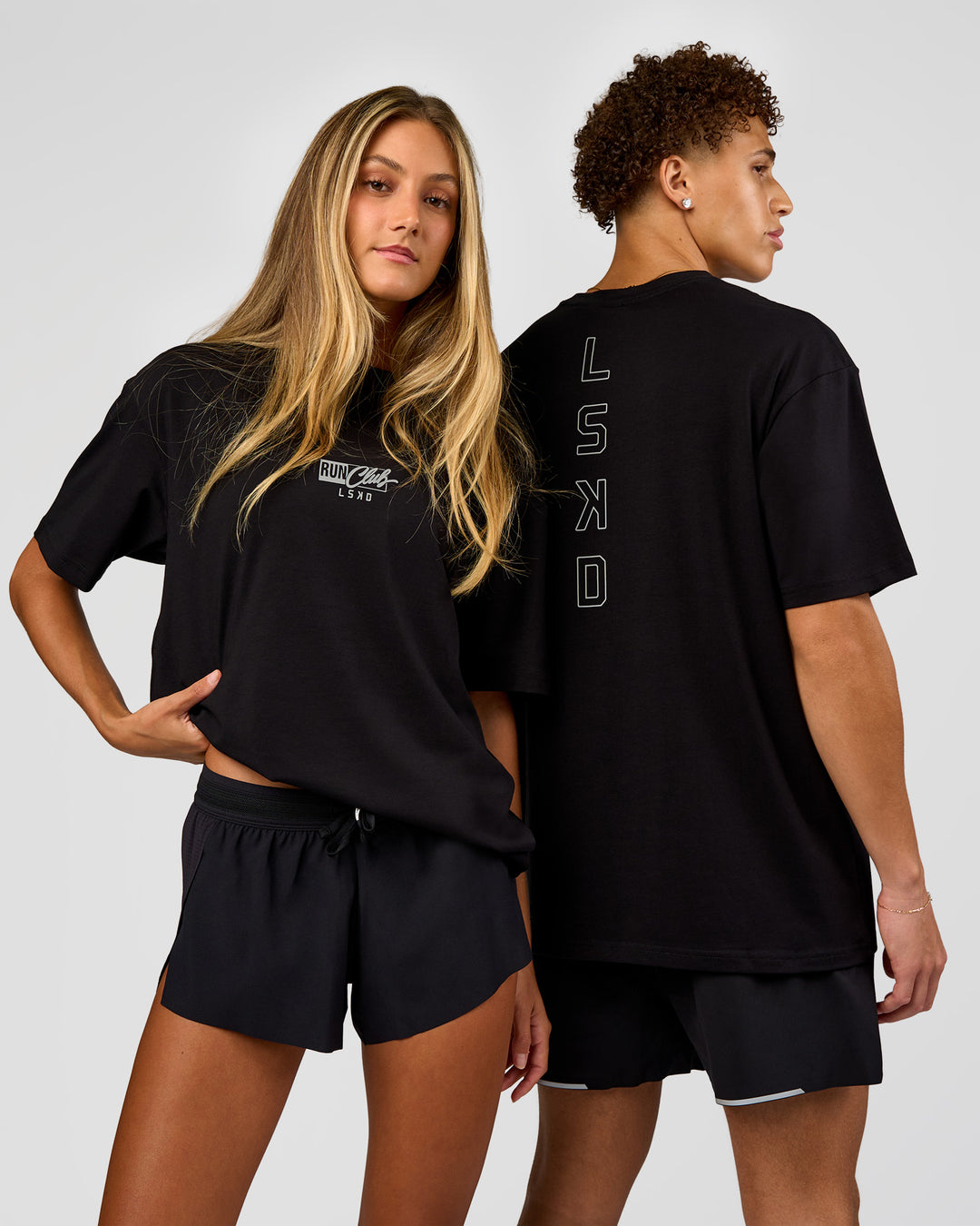 Duo wearing Run Club Script FLXCotton Oversized Tee - Black-Alloy | Model:Both | Size:Duo - view 1