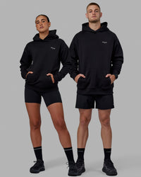 Duo wearing Unisex RUN-CLUB Hoodie Oversize - Black | Thumbnail Index: 6