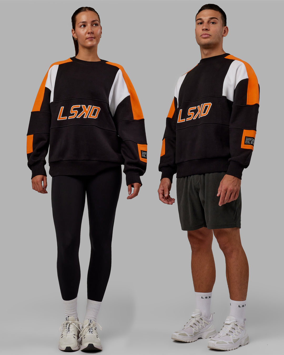 Duo wearing Unisex Slam Sweater Oversize - Black-Ultra Orange - view 1