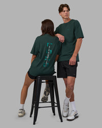 Duo wearing Unisex Strike Through FLXCotton Tee Oversize - Vital Green-Alexandrite | Model:Both | Size:Duo | Thumbnail Index: 0