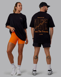Duo wearing Unisex Trust The Process 2.0 FLXCotton Tee Oversize - Black-Vibrant Orange | Thumbnail Index: 0