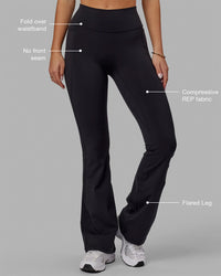 Woman wearing Fusion Ultra High-Rise Flared Legging Pockets - Black | Model:Milly | Size:S | Thumbnail Index: 1