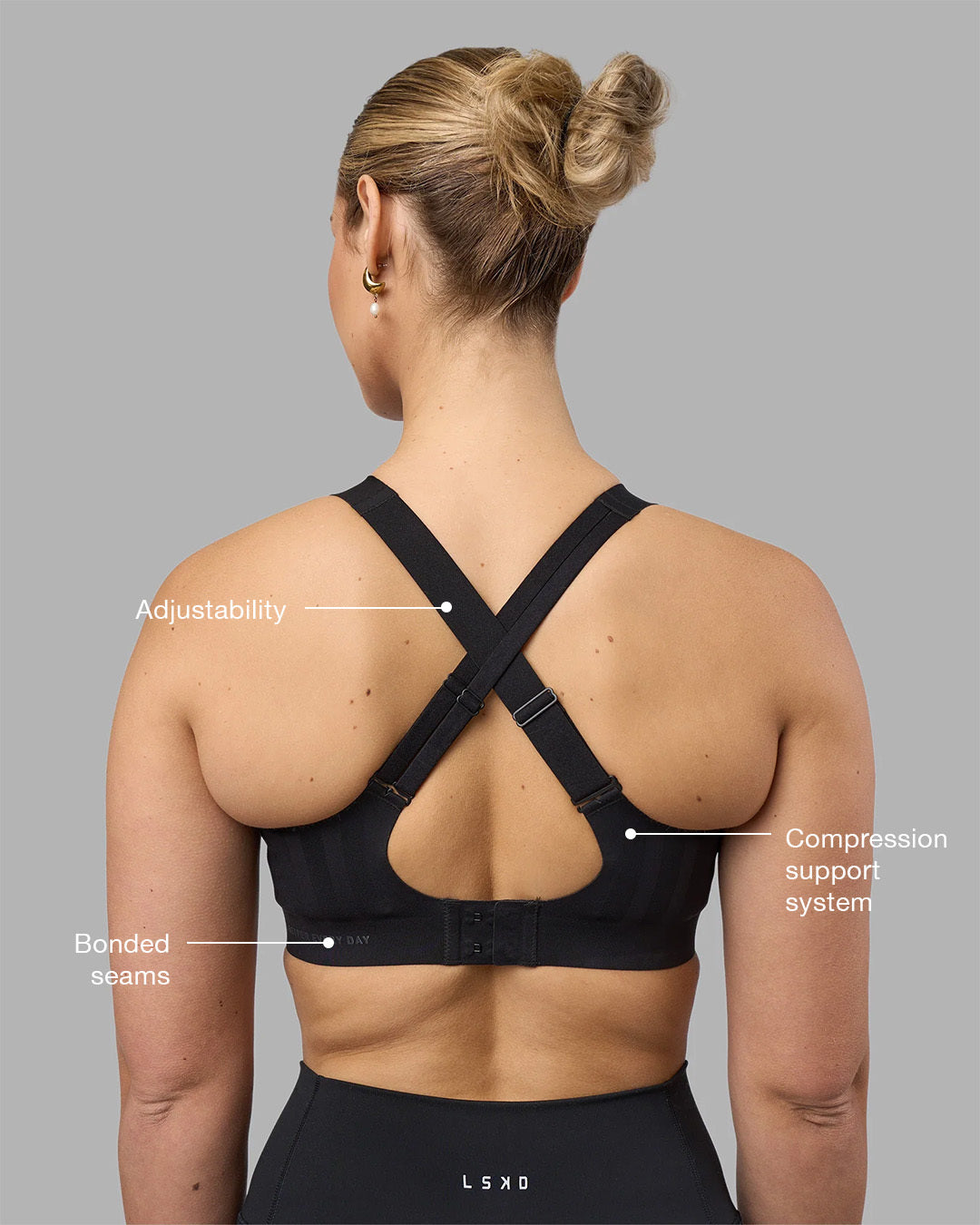 Woman wearing Stability Sports Bra - Black | Model:Amy | Size:S (D-E Cup) - view 2