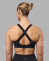 Woman wearing Stability Sports Bra - Black | Model:Amy | Size:S (D-E Cup) | Thumbnail Index: 1