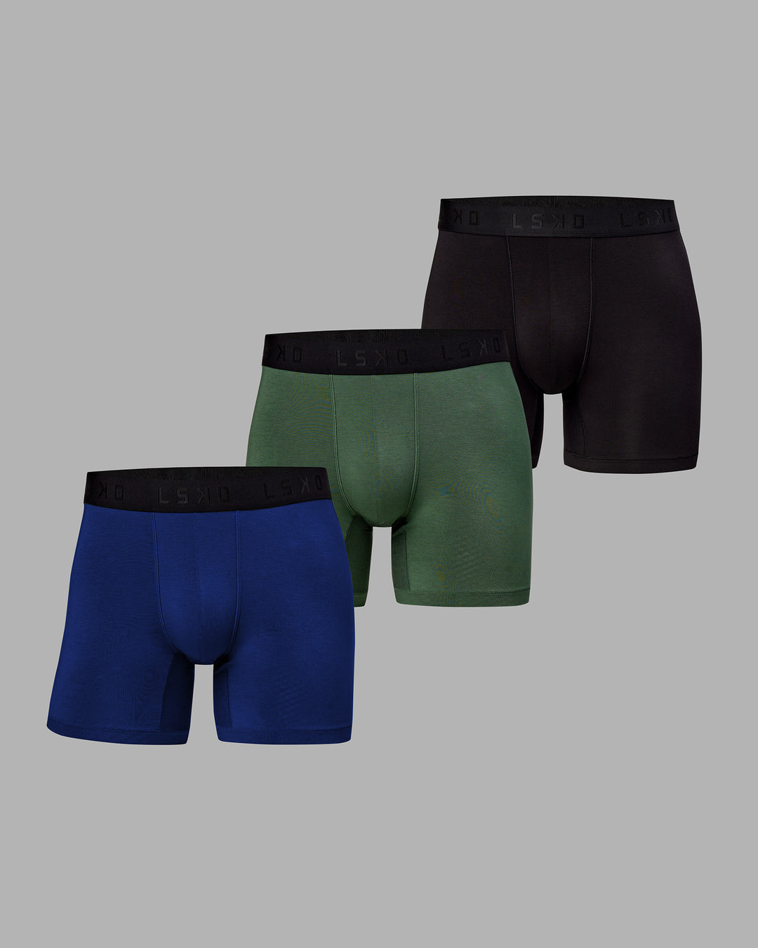 Man wearing MVP Trunks 3 Pack - Black/Cilantro/Midnight Blue - view 1