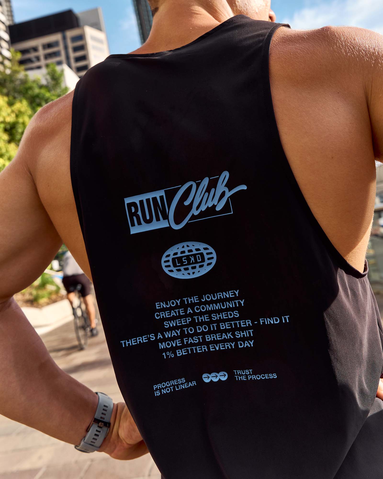 Man wearing Cadence Run Club Script Values Tank - Black-Palace Blue | Model:Cooper | Size:L