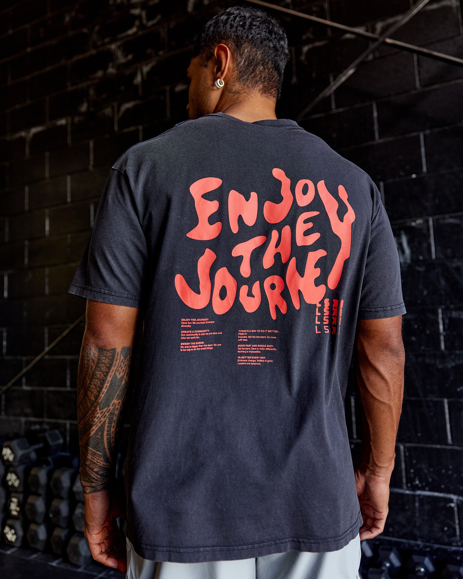 Man wearing Inferno Journey FLXCotton Oversized Tee - Black Washed-Ultra Orange | Model:Xav | Size:L