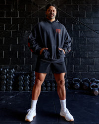 Man wearing Journey Washed Unisex Oversize Hoodie - Black-Ultra Orange | Model:Hiko | Size:L | Thumbnail Index: 1