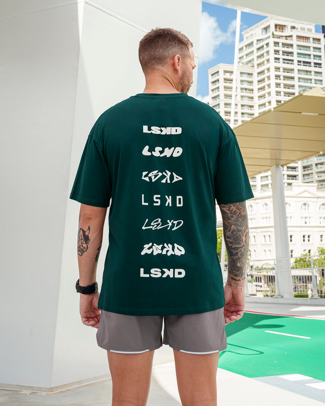 Man wearing Variation FLXCotton Oversized Tee in Dark Moss-Digital Mist | Size:L - view 1