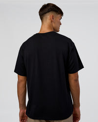 Man wearing 1% Better Every Day EST FLXCotton Oversized Tee - Black | Model:Jackson | Size:L | Thumbnail Index: 4
