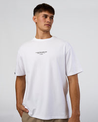 Man wearing 1% Better Every Day EST FLXCotton Oversized Tee - White | Model:Jackson | Size:L | Thumbnail Index: 1