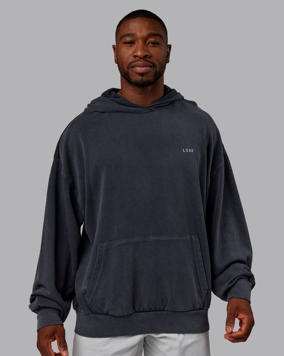 Man wearing 1% Better Value Series Oversized Hoodie - Black-Violet Ray | Model:Sam | Size:L - view 3
