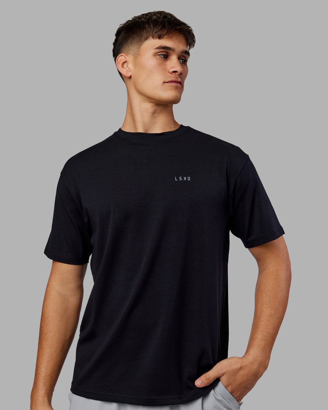 Man wearing 1% Better Value Series FLXCotton Tee Oversize - Black-Black | Model:Jackson | Size:L - view 2