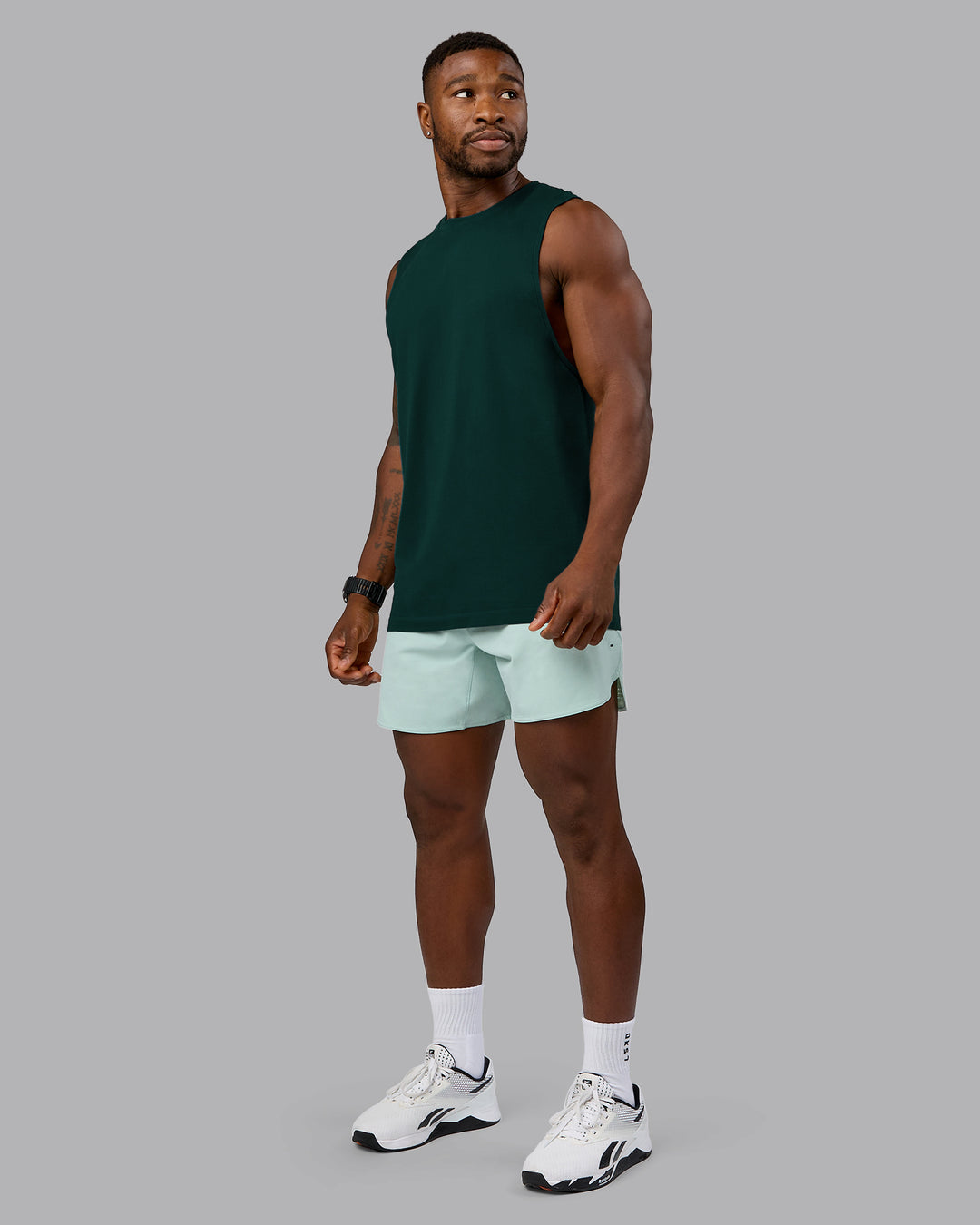 Man wearing AeroFLX+ Seamless Muscle Tank - Dark Moss/Dark Moss Marl | Model:Sam | Size:L - view 1