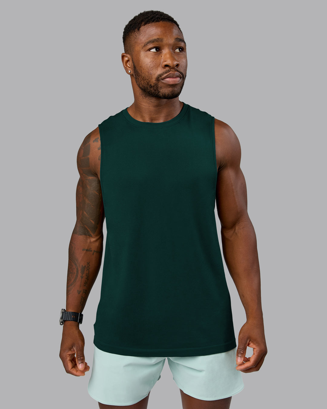Man wearing AeroFLX+ Seamless Muscle Tank - Dark Moss/Dark Moss Marl | Model:Sam | Size:L - view 2