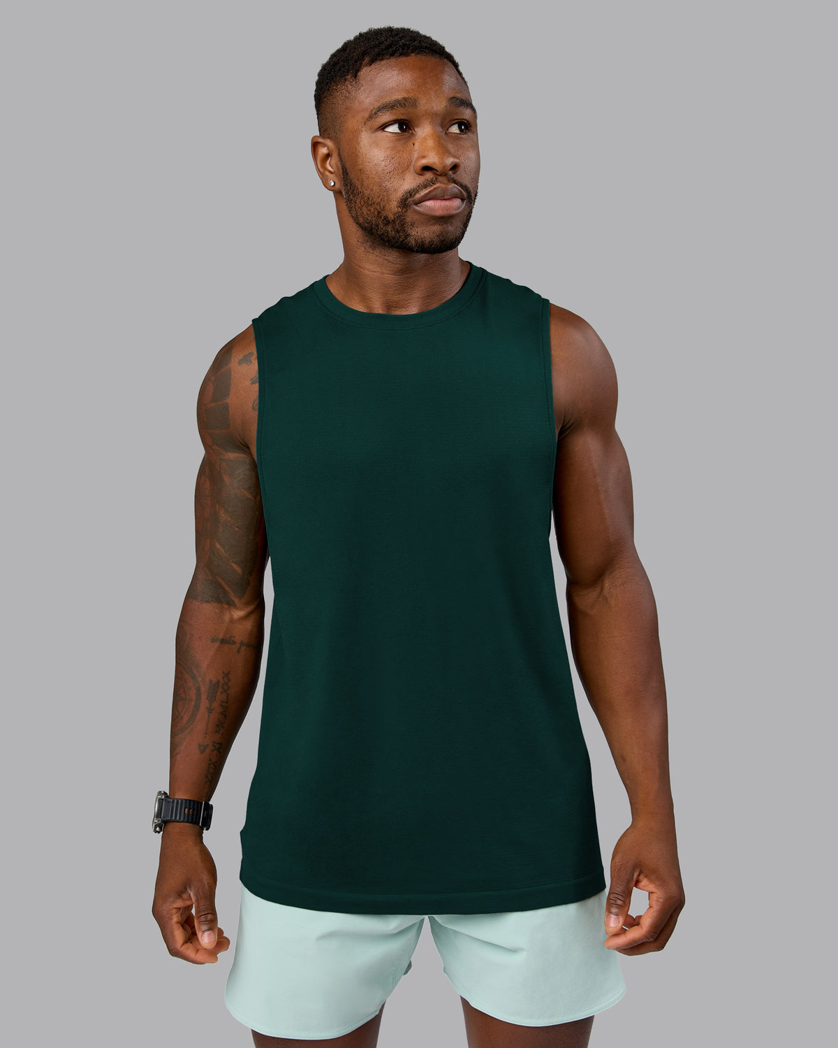 Man wearing AeroFLX+ Seamless Muscle Tank - Dark Moss/Dark Moss Marl | Model:Sam | Size:L
