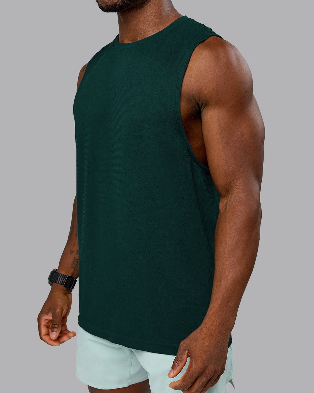 Man wearing AeroFLX+ Seamless Muscle Tank - Dark Moss/Dark Moss Marl | Model:Sam | Size:L - view 4