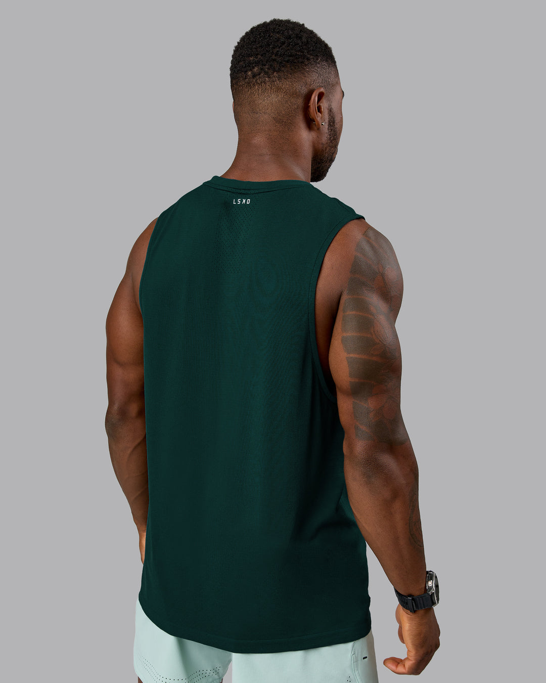 Man wearing AeroFLX+ Seamless Muscle Tank - Dark Moss/Dark Moss Marl | Model:Sam | Size:L - view 3