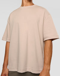 Man wearing AfterDark ZeroCrease Oversized Tee - Shale Beige | Model:Jackson | Size:L | Thumbnail Index: 6