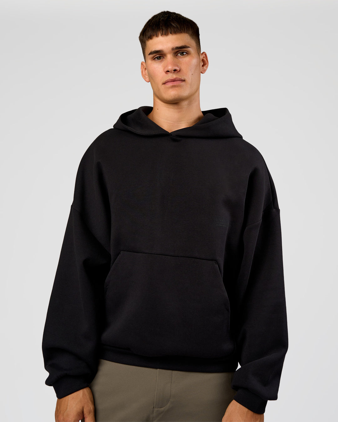 Man wearing AfterDark ZeroCrease Oversized Hoodie - Black | Model:Jackson | Size:L - view 10