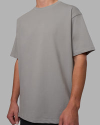Man wearing Base FLXCotton Tee Oversized - Circular-Grey  Model:Brandon | Size:L | Thumbnail Index: 0