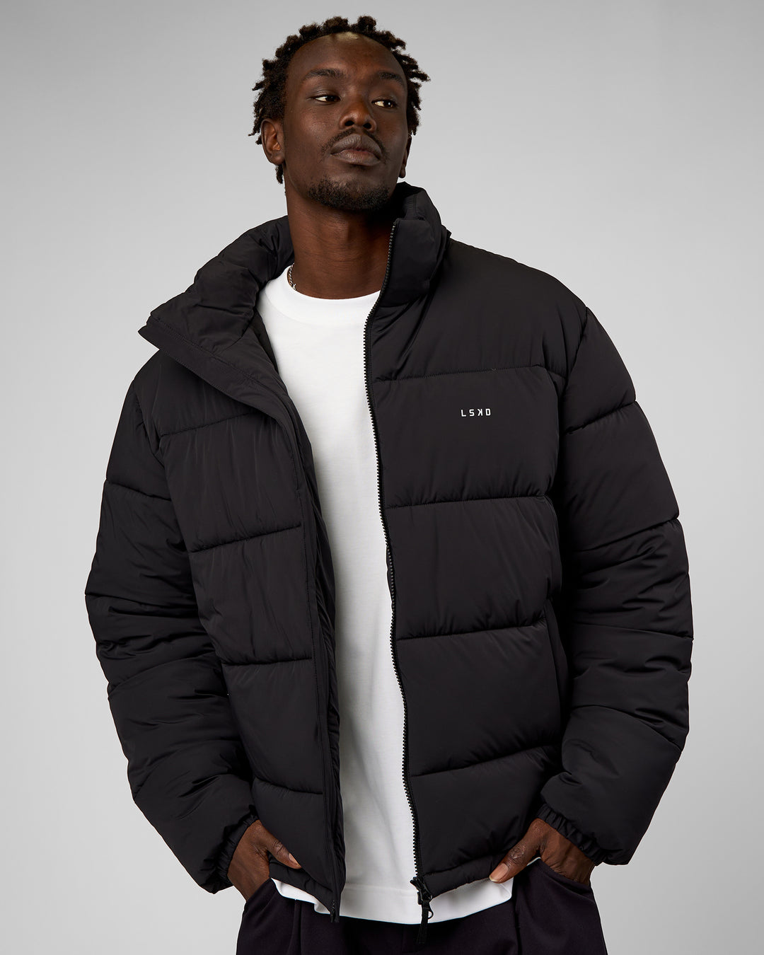 Man wearing Base Puffer Jacket - Black | Model:Okello | Size:L - view 1