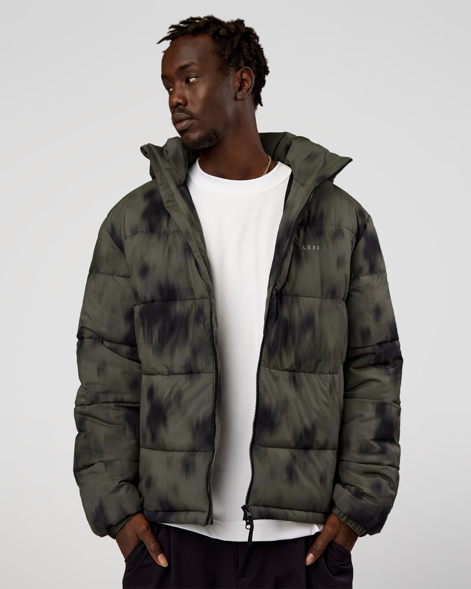 Man wearing Base Puffer Jacket - Camo Washed Walnut Grey | Model:Okello | Size:L