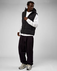 Man wearing Base Puffer Vest - Black | Model:Okello | Size:L | Thumbnail Index: 1