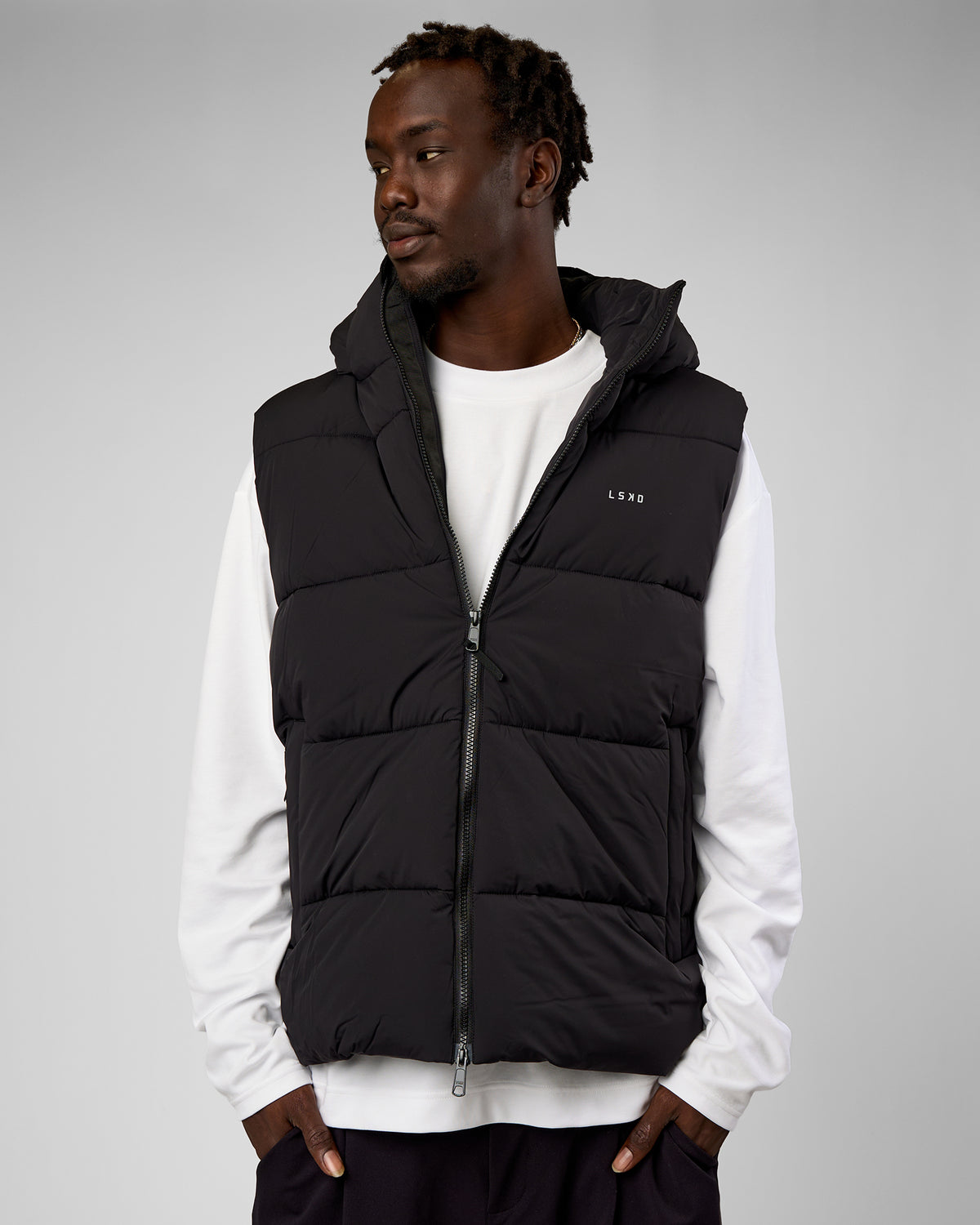 Man wearing Base Puffer Vest - Black | Model:Okello | Size:L