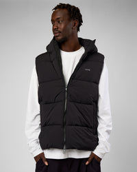 Man wearing Base Puffer Vest - Black | Model:Okello | Size:L | Thumbnail Index: 0