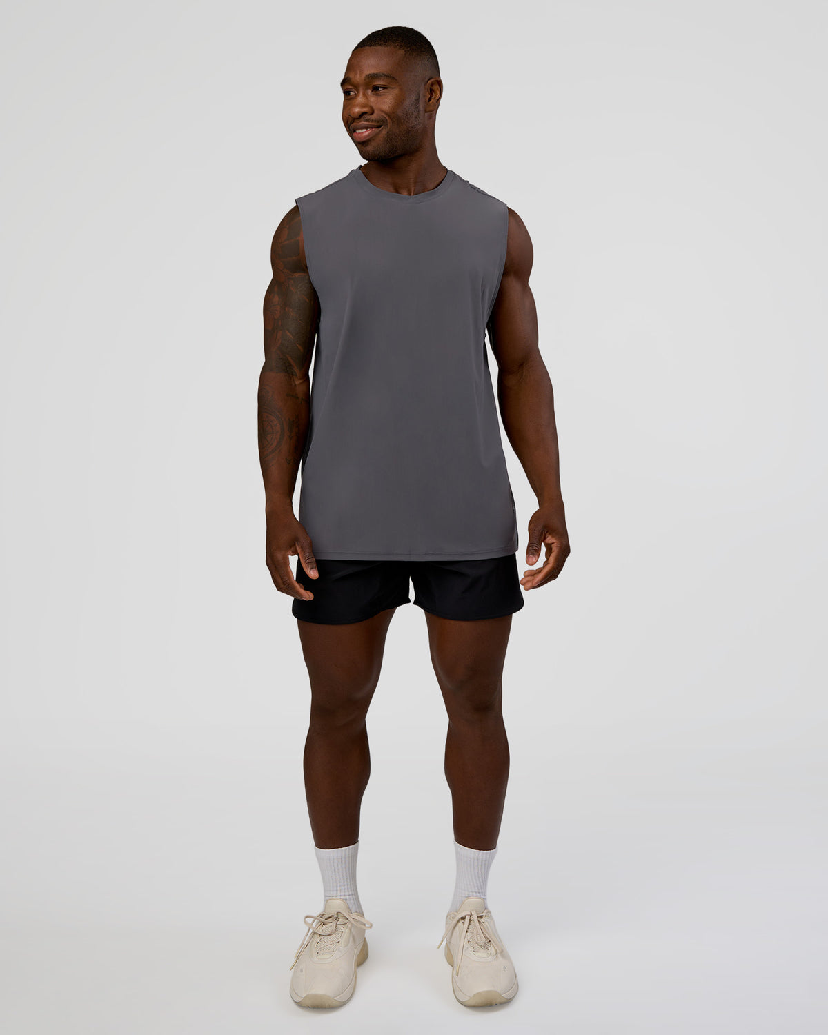 Man wearing Cadence MicroMotion Muscle Tank - Dark Storm | Model:Sam | Size:L