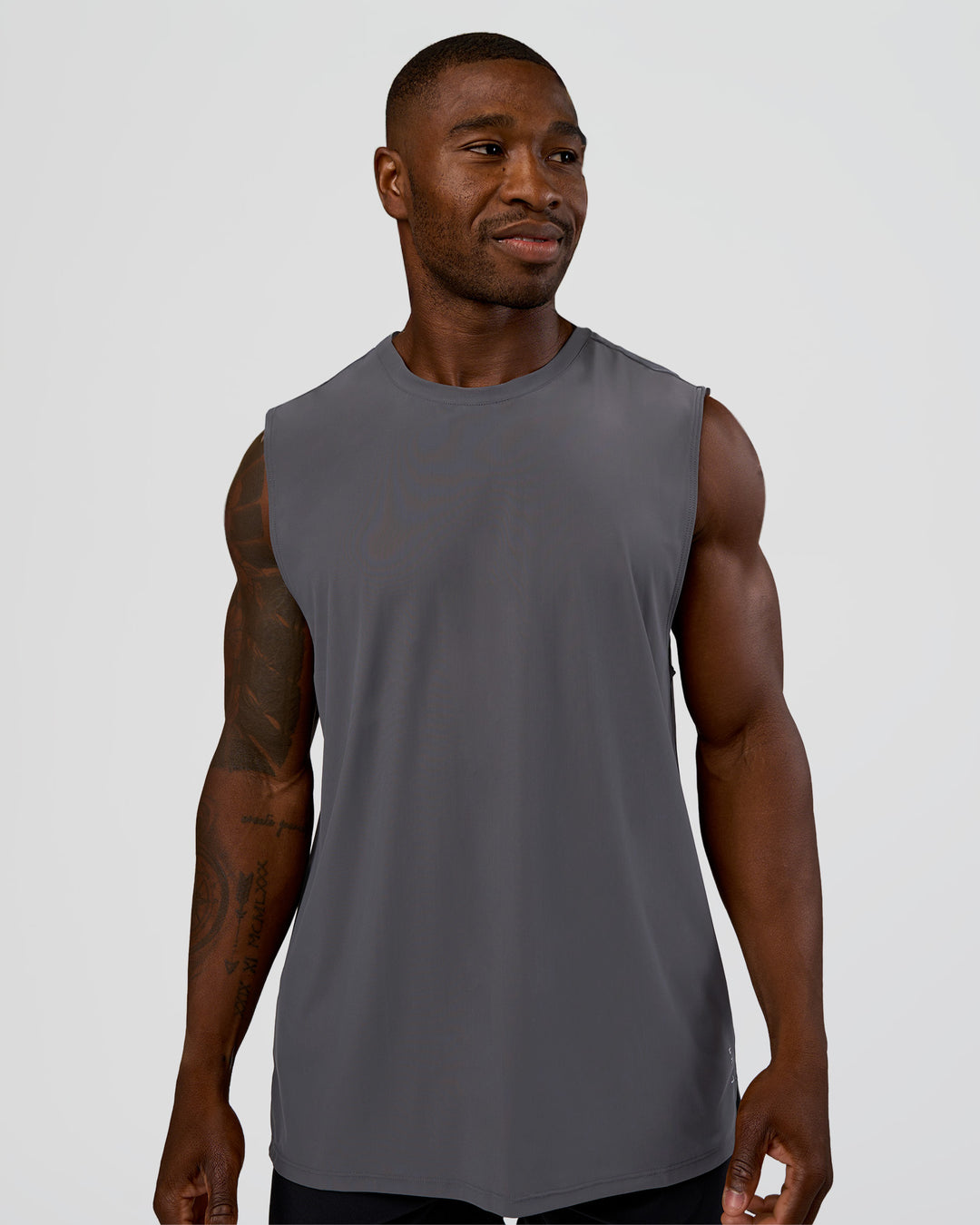 Man wearing Cadence MicroMotion Muscle Tank - Dark Storm | Model:Sam | Size:L - view 1