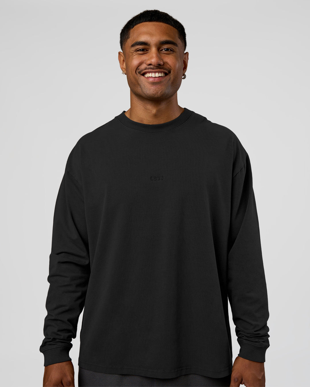 Man wearing Classic Heavyweight FLXCotton Oversized Long Sleeve Tee - Washed Black-Black | Model:Xav | Size:L - view 1