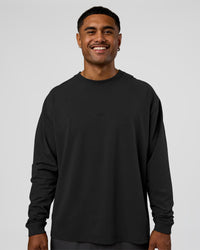 Man wearing Classic Heavyweight FLXCotton Oversized Long Sleeve Tee - Washed Black-Black | Model:Xav | Size:L | Thumbnail Index: 0