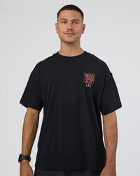 Man wearing GTC Heavyweight Oversized Tee - Black-Cantaloupe | Model:Nikola | Size:L | Thumbnail Index: 1