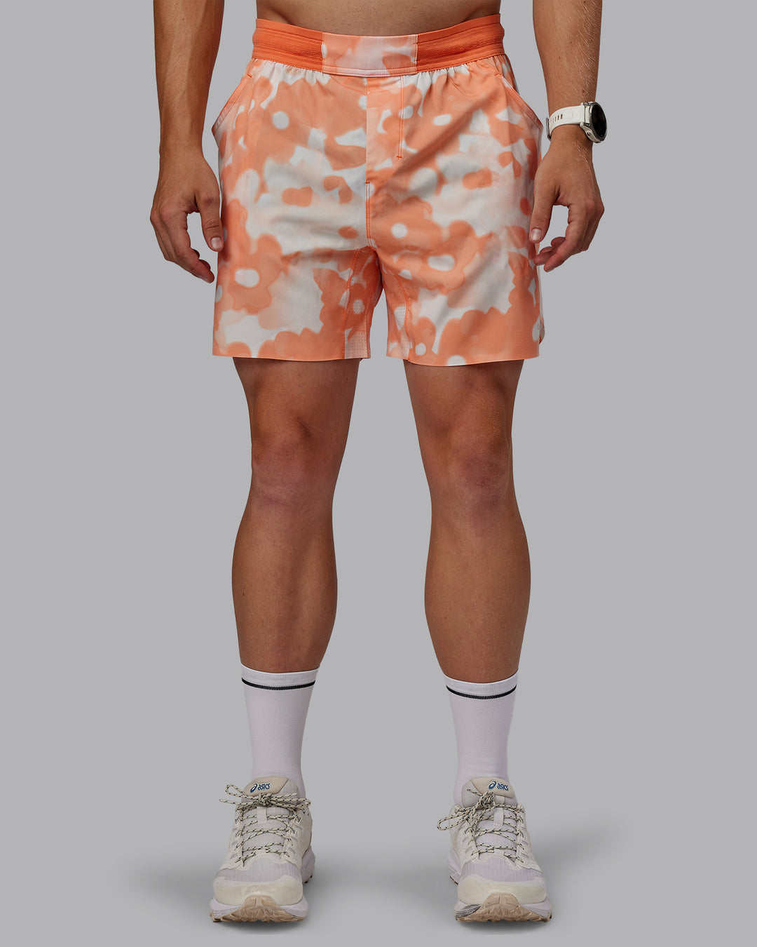 Man wearing Grand Slam 6" Shorts in Wildflower Cantaloupe | Size:L - view 1