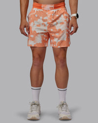 Man wearing Grand Slam 6" Shorts in Wildflower Cantaloupe | Size:L | Thumbnail Index: 0