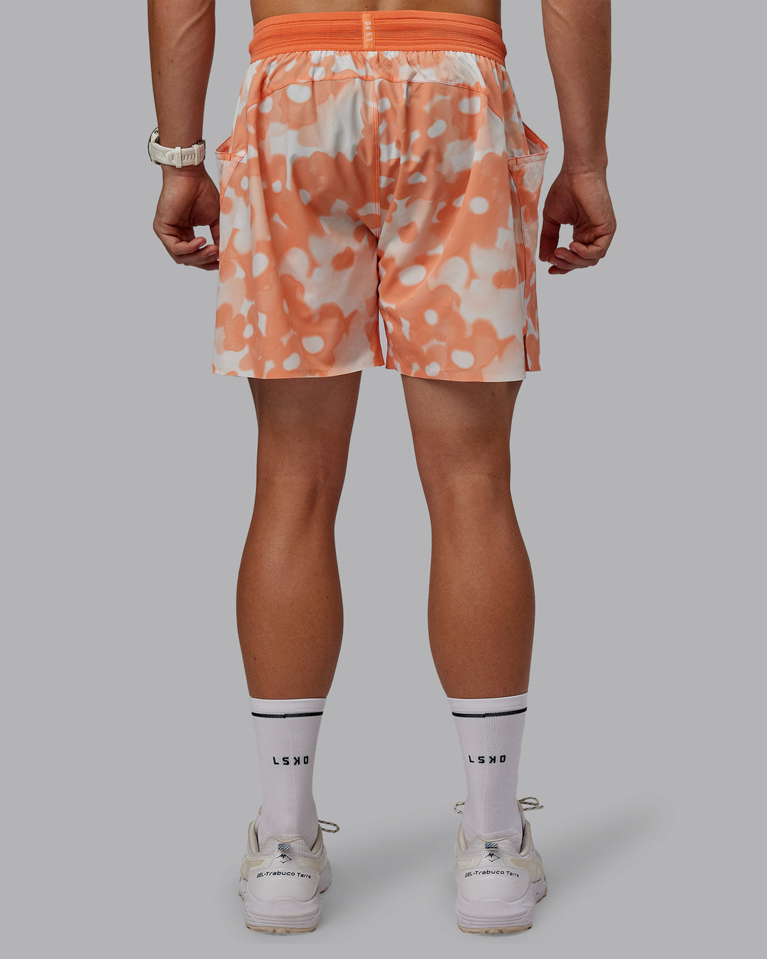 Man wearing Grand Slam 6" Shorts in Wildflower Cantaloupe | Size:L - view 4