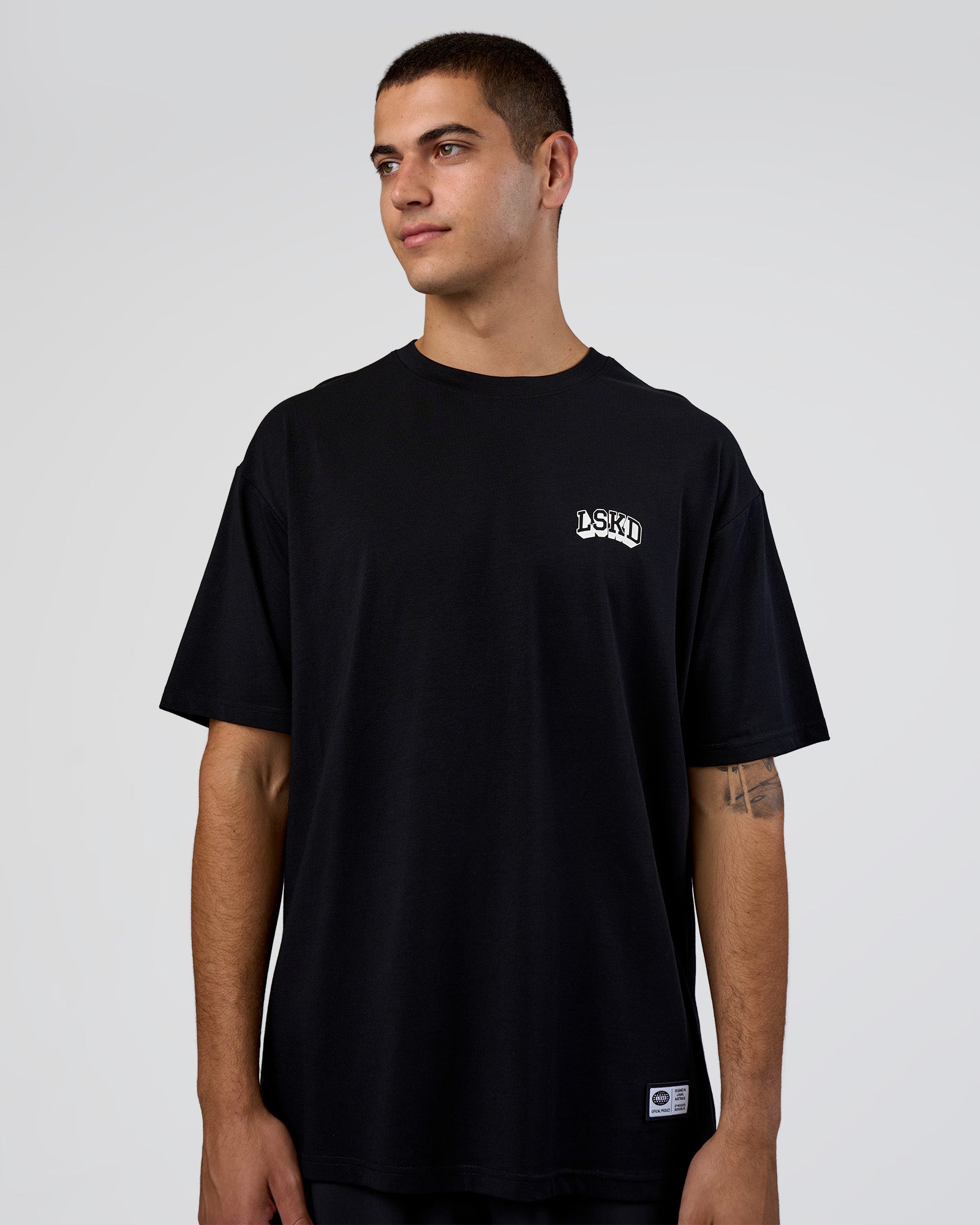 Man wearing Grid FLXCotton Oversized Tee - Black-White | Model:Zoran | Size:L
