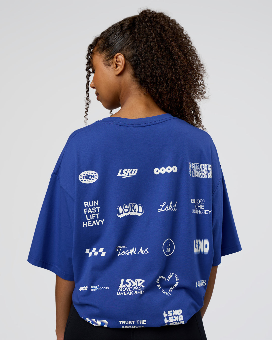 Woman wearing Grid FLXCotton Oversized Tee - Power Cobalt-White | Model:Jordan | Size:L - view 4