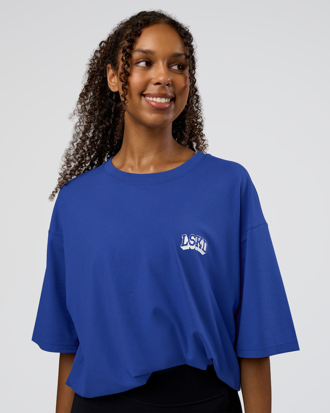 Woman wearing Grid FLXCotton Oversized Tee - Power Cobalt-White | Model:Jordan | Size:L - view 3