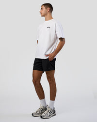 Man wearing Grid FLXCotton Oversized Tee - White-Black | Model:Zoran | Size:L | Thumbnail Index: 1