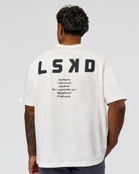 Man wearing Hype Heavyweight Unisex Oversized Tee - Off White-Black | Model:Xavier | Size:L | Thumbnail Index: 12