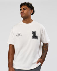 Man wearing Hype Heavyweight Unisex Oversized Tee - Off White-Black | Model:Xavier | Size:L | Thumbnail Index: 6