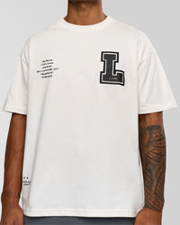 Man wearing Hype Heavyweight Unisex Oversized Tee - Off White-Black | Model:Xavier | Size:L | Thumbnail Index: 7