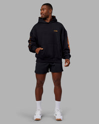 Man wearing Hyped Unisex Oversized Hoodie - Black-Vibrant Orange | Model:Sam | Size:L | Thumbnail Index: 8
