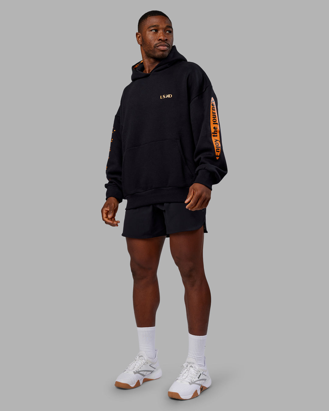 Man wearing Hyped Unisex Oversized Hoodie - Black-Vibrant Orange | Model:Sam | Size:L - view 11